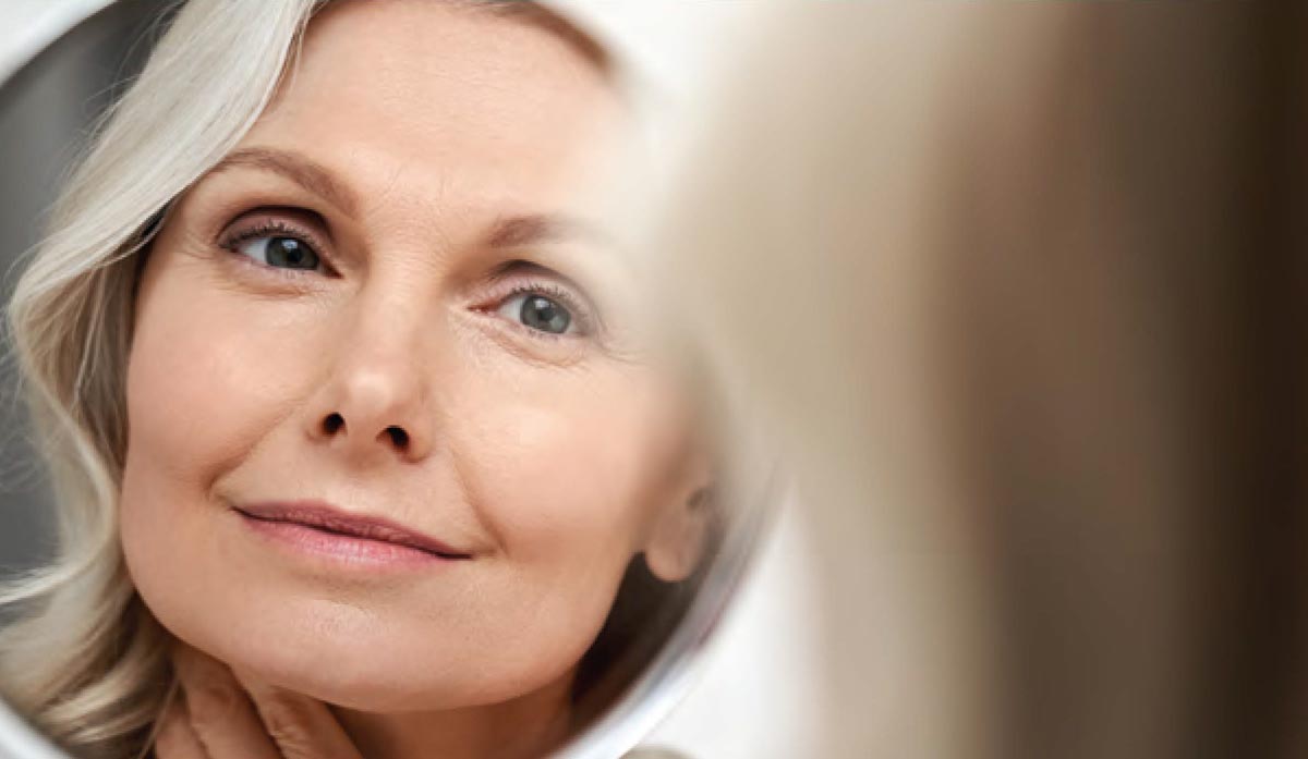 woman admires results from advanced aesthetics